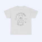 The Thank God I'm Gay Shirt is light gray and features a simple line drawing of a teddy bear surrounded by hearts and flowers, with "THANK GOD IM GAY" printed above and below the bear.