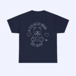 The Thank God I'm Gay Shirt is navy blue, featuring a white line drawing of a teddy bear with hearts and flowers, plus bold “THANK GOD IM GAY” text above and below the bear.