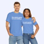 A man and woman stand side by side, smiling in matching Hey Quick Question Are You Kidding Me Shirts, with the man’s arm around her shoulders as they show off the light blue shirts printed with the funny white phrase.