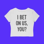 The I Bet On Us You Shirt is a white crop top with bold black "I BET ON US, YOU?" text on the front, shown against a solid bright blue background.