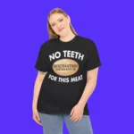 A person with long blonde hair smiles, wearing the No Teeth Destination Smokehouse For This Meat Shirt, standing against a solid bright purple background.