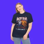 A woman with long blonde hair stands against a purple background, wearing the Angry Runs Bills James Cook III Shirt featuring a football player and illustrated lion graphic.